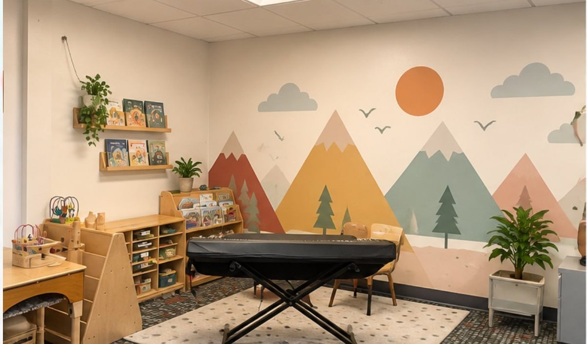 The music and reading area with a keyboard, bookshelves and a pastel mountain mural